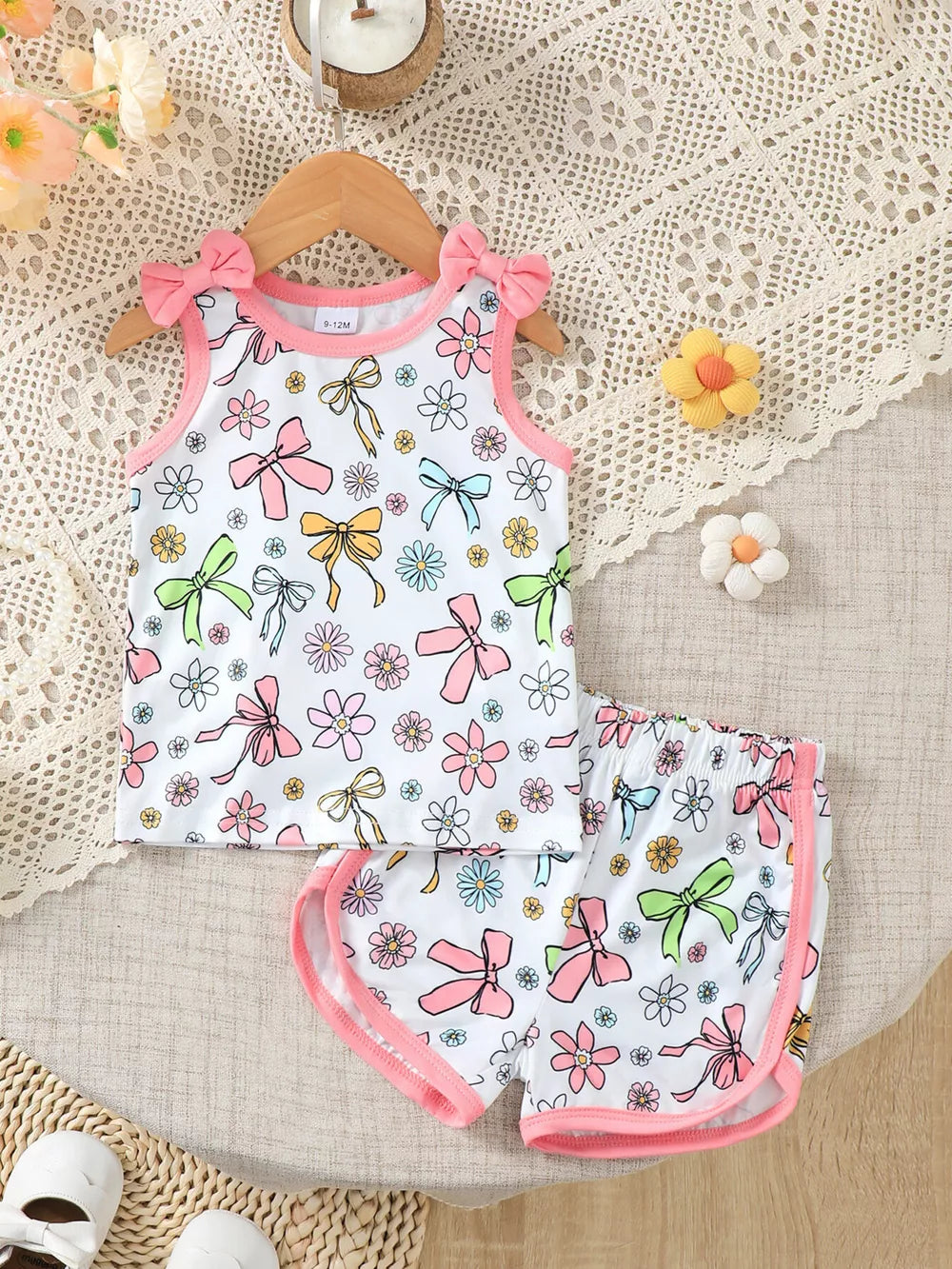 Toddler floral bowknot tank top and shorts set with pink trim and bow shoulder details.