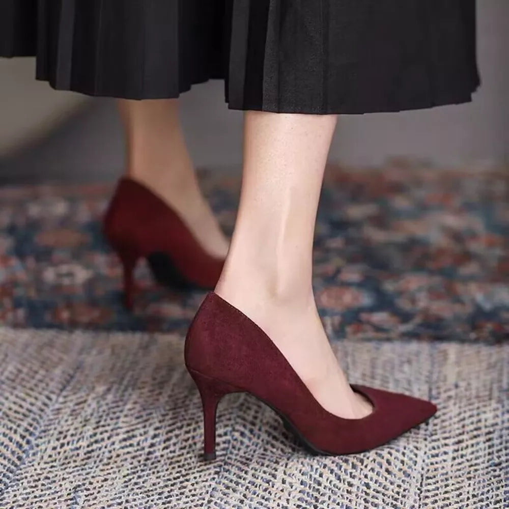Point toe stiletto pumps in wine red suede, classic style.
