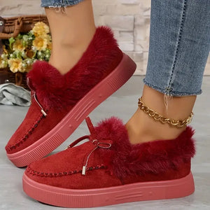 Red suede loafers with shearling trim and bow detail.
