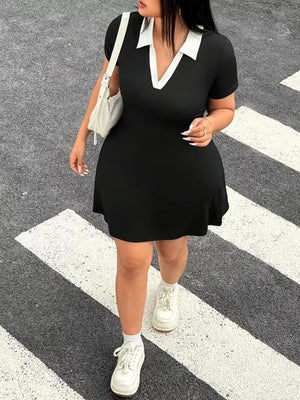 Black plus-size bodycon mini dress with white contrast collar and short sleeves.