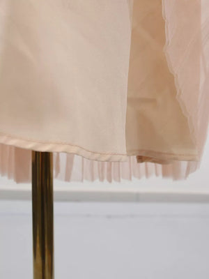 Embroidered tulle midi dress with pleated hem detail in a soft peach hue.
