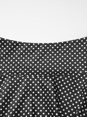 Black polka dot two-piece set with ruffled crop top and flared skirt detail.