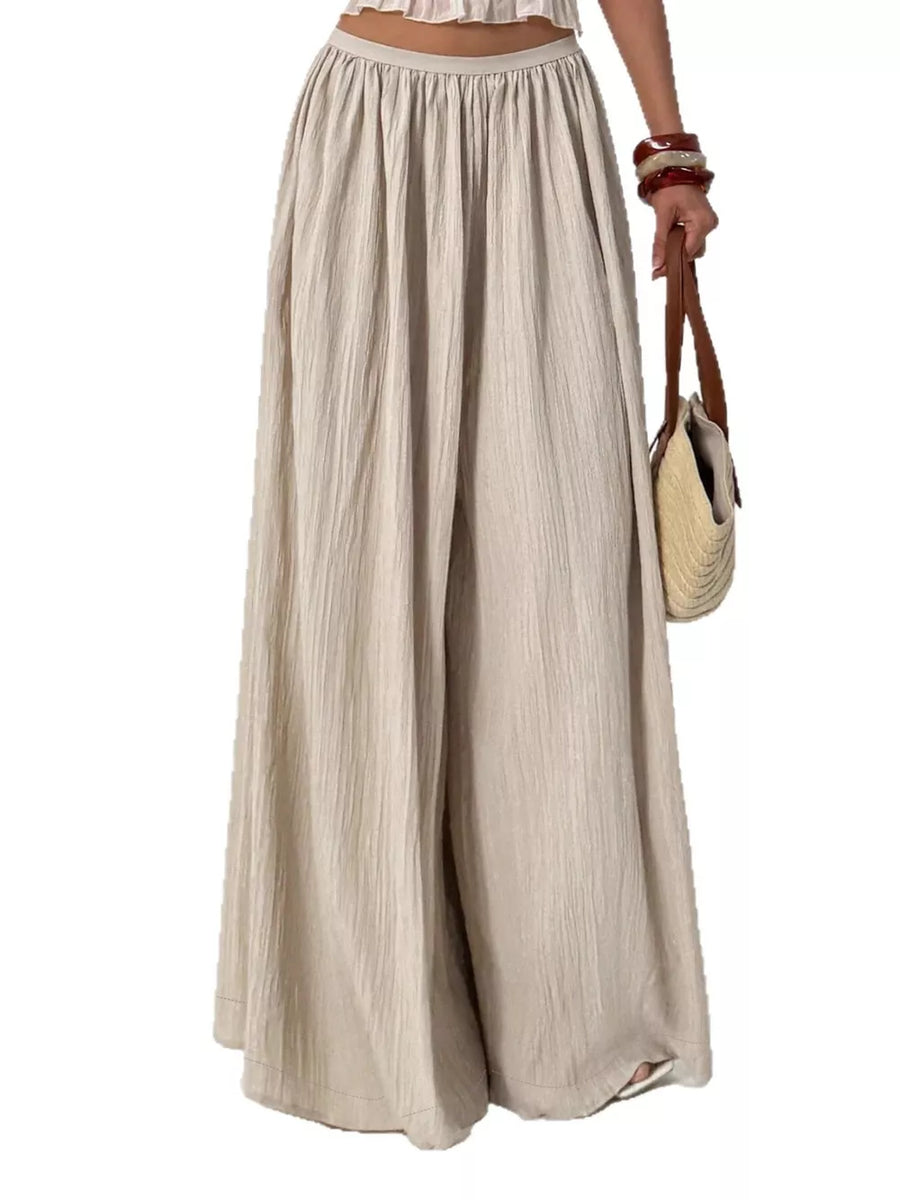 Textured beige cotton maternity pants with gathered waist and wide legs.