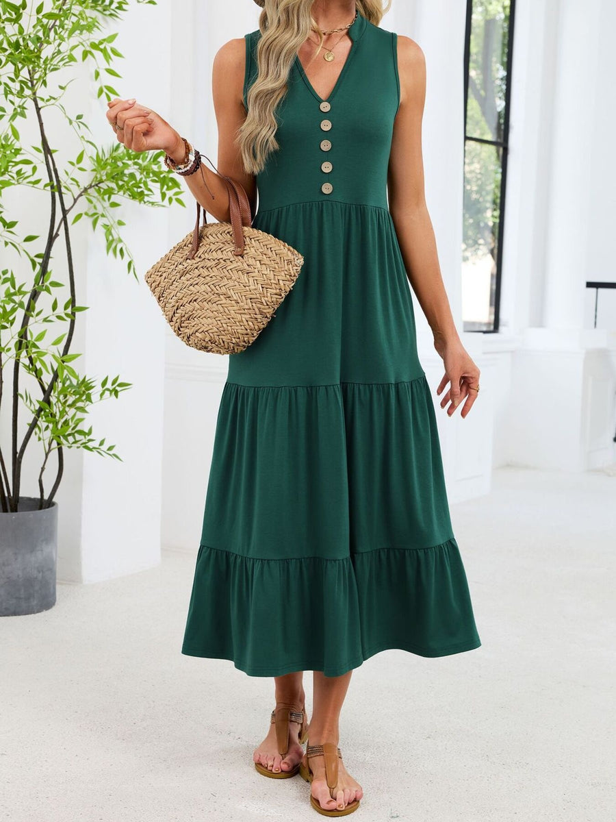 Dark green tiered midi dress with notched V-neck and decorative buttons.