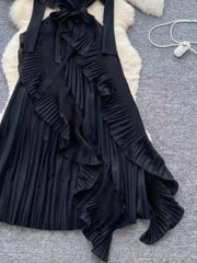 Black midi dress with ruffled asymmetrical front and pleated skirt