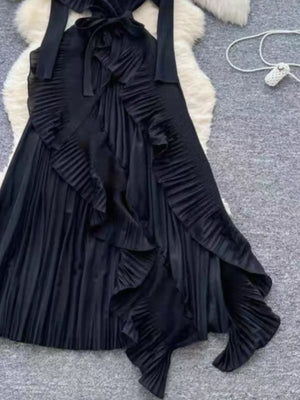 Black midi dress with ruffled asymmetrical front and pleated skirt