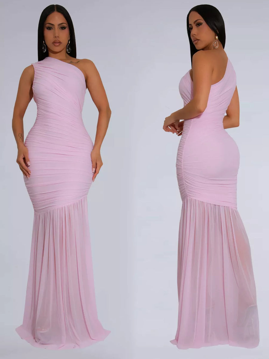 Blush pink ruched one-shoulder bodycon maxi dress with sheer flowing skirt.