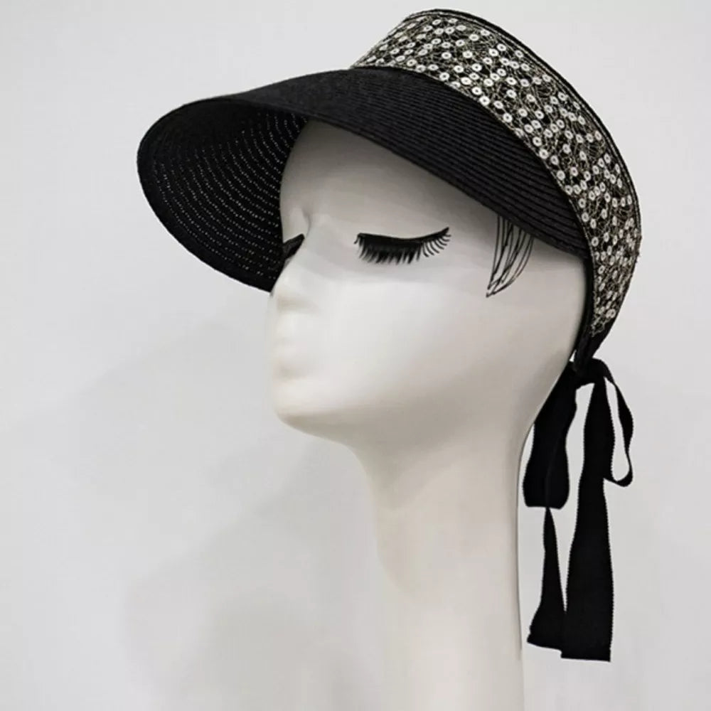 Sparkling straw visor hat in black with decorative sequin band and ribbon tie.