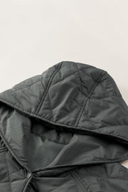 Diamond quilted hooded snap jacket in light gray with visible snap closure detail.
