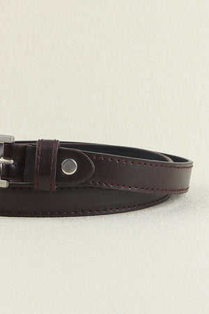 Slimline chocolate leatherette belt with silver buckle and tonal stitching.