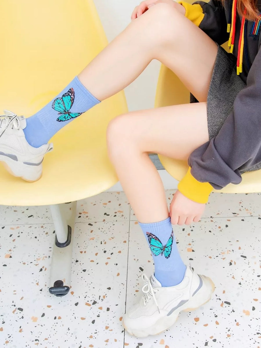 Blue socks featuring elastic cuff and butterfly-print