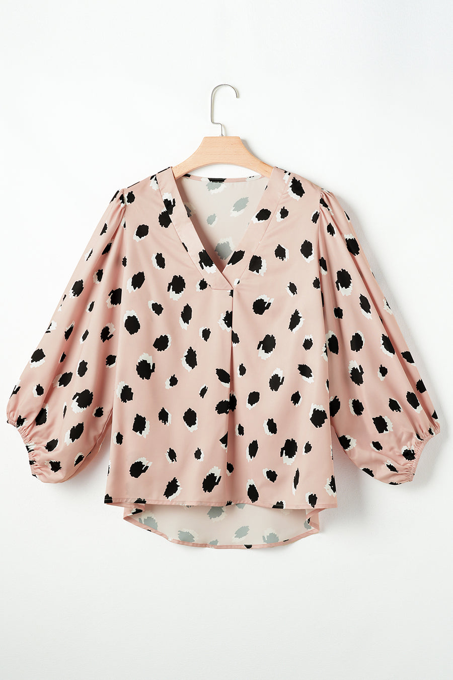 Pink silk blouse with blouson sleeves and a spot print.
