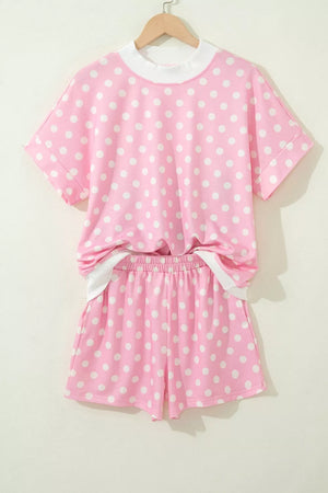 Pink polka dot polyester top and shorts set with white trim.