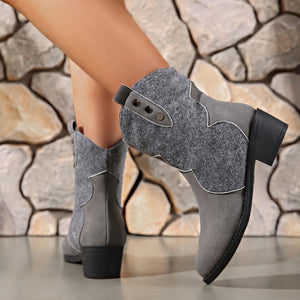 Gray suede and felt western-inspired ankle boots with decorative stitching and button details.