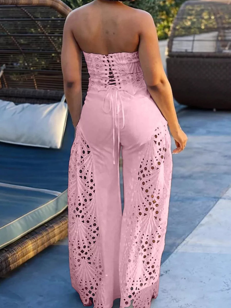 Pink strapless two-piece outfit with corset lace-up back and intricate openwork wide-leg pants.