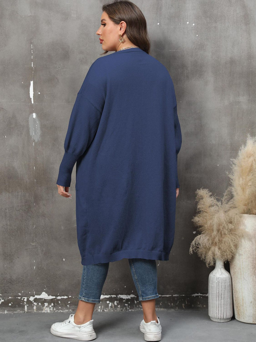 Oversized dark blue knit duster cardigan with long sleeves and ribbed cuffs.