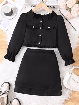 Black ruffle trim top and skirt set with pearl buttons and pocket details.