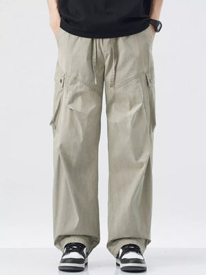 Loose fit khaki cargo pants with drawstring waist and multiple pockets.