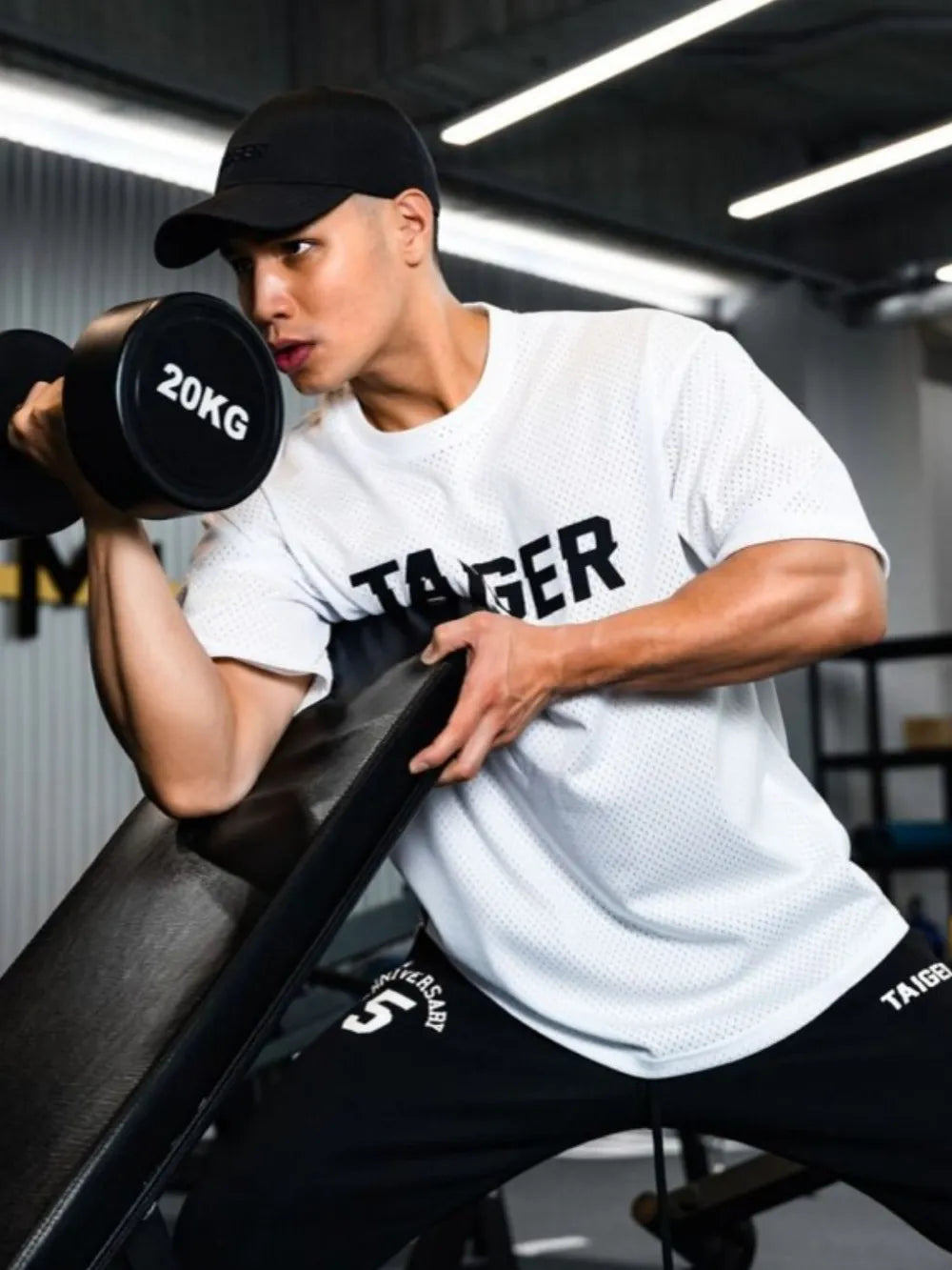 White mesh oversized t-shirt with black Taiger graphic and short sleeves.