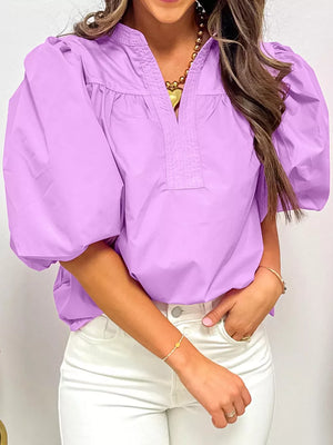Purple cotton shirt with notched collar, puff sleeves, and gathered neckline.