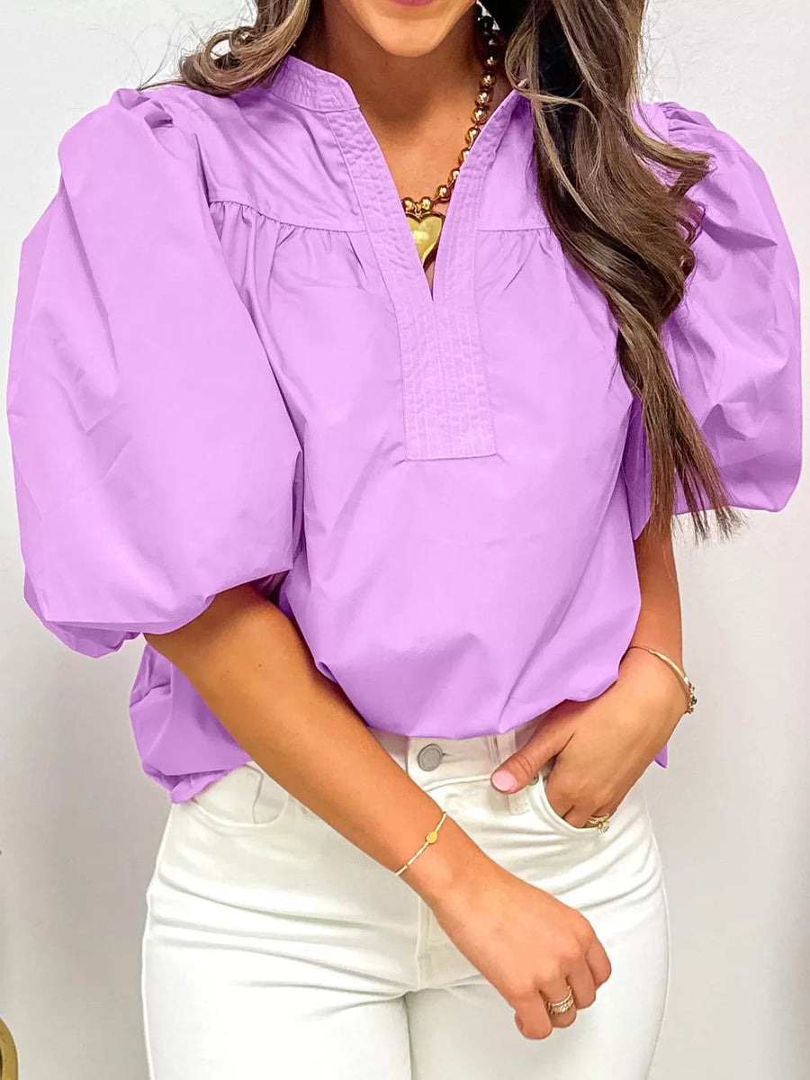 Purple cotton shirt with notched collar, puff sleeves, and gathered neckline.