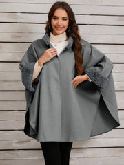 Gray cape coat with faux fur trim on collar and cuffs, open front style.