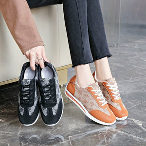 Lace-up round toe sneakers in black and khaki color with patterned fabric and leather accents.