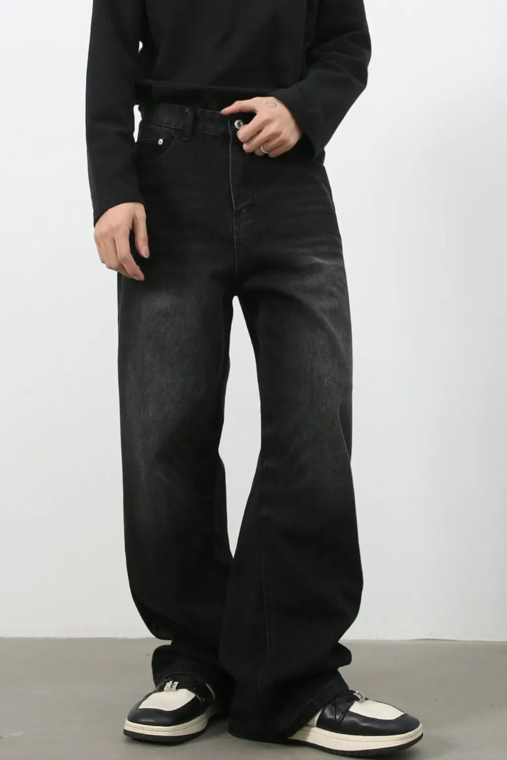 Faded black denim palazzo jeans with a relaxed, oversized fit.