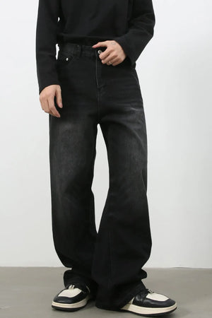 Faded black denim palazzo jeans with a relaxed, oversized fit.