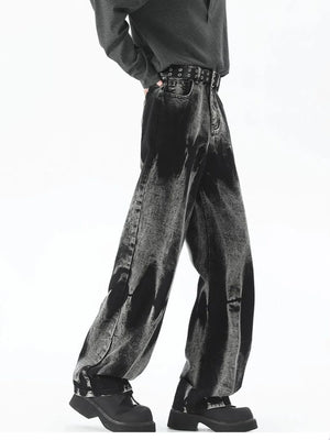 Men's black relaxed fit jeans with acid wash detail and studded belt.
