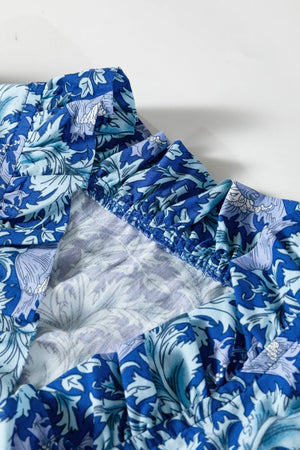 Blue floral cotton midi dress with frilled cuffs and cinched waist detail