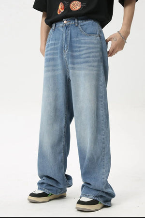 Oversized baggy denim jeans in medium wash, featuring a relaxed fit and casual styling.