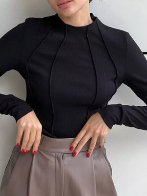 Black seam-detail mock neck t-shirt with long sleeves and ribbed texture.