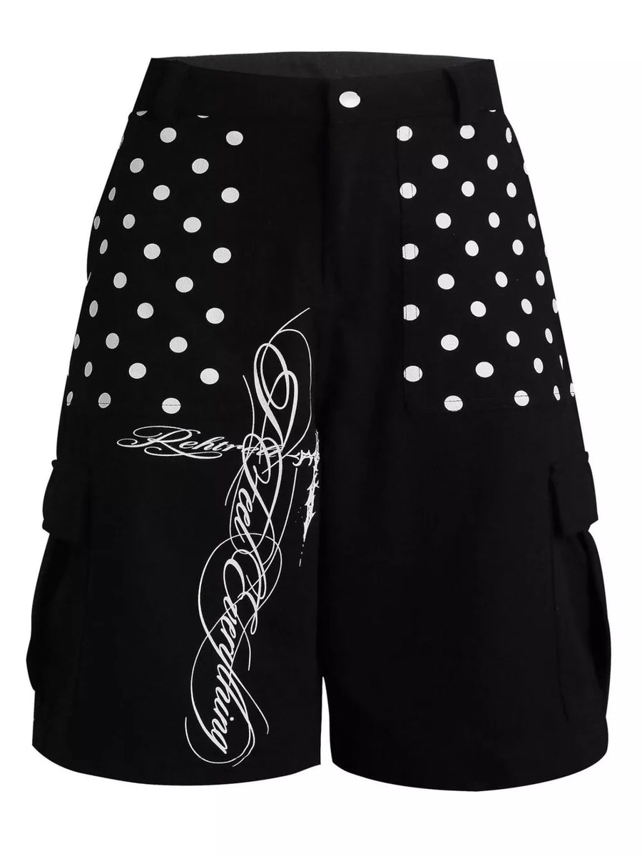 Black cargo shorts with white polka dot panels and script graphic.
