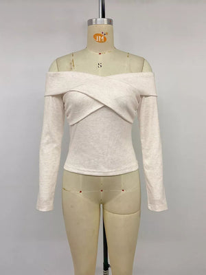 Off-the-shoulder long sleeve top in light heathered beige with a crisscross neckline.