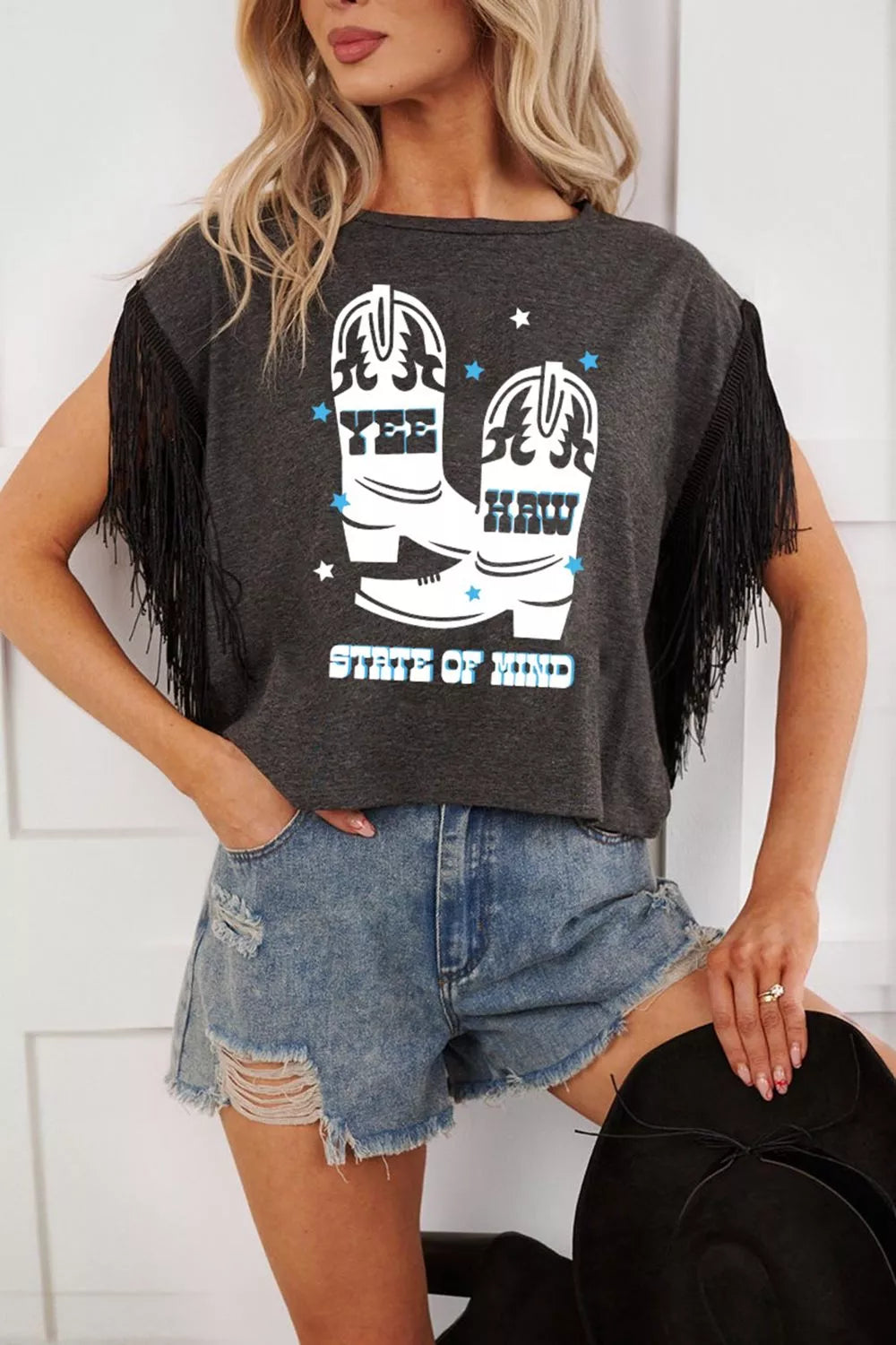 Fringe graphic tee with cowboy boots and text, black cotton t-shirt with fringe sleeves.