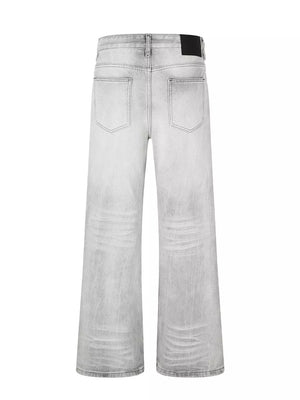 Men's gray vintage wash wide leg jeans with distressed details.