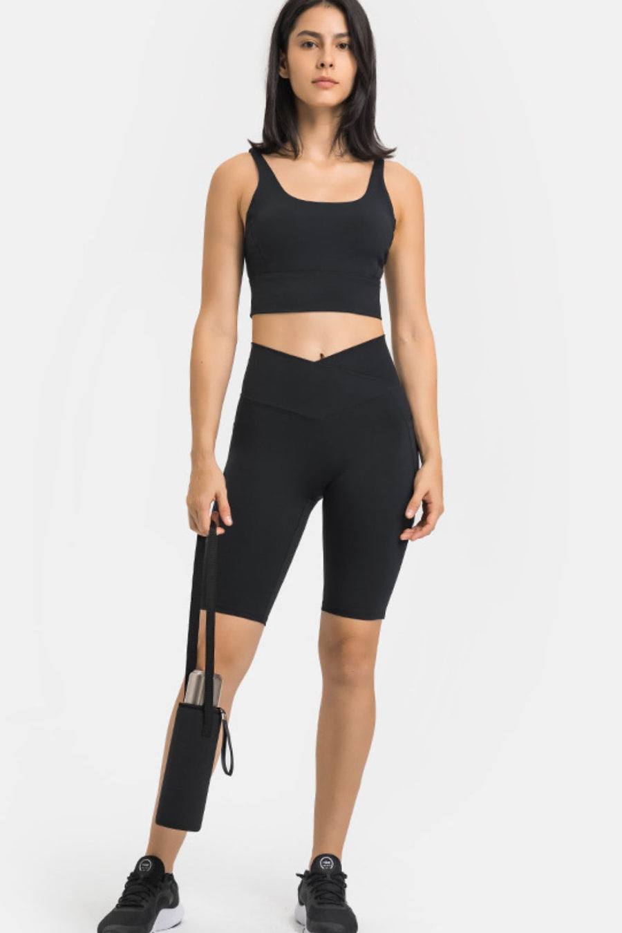 Black V-waist pocketed performance biker shorts with a side pocket holding a water bottle.