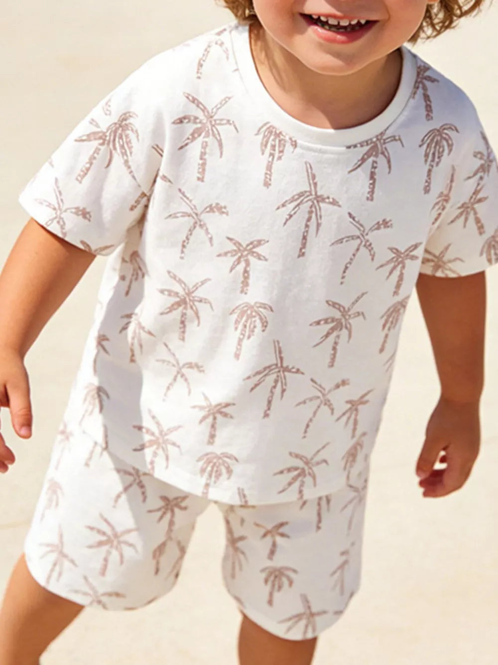 Boys' cotton two-piece set with tropical palm print in beige.
