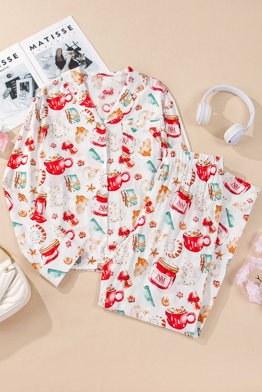 White collared pajama set with festive holiday print of mugs, gifts, and cookies.