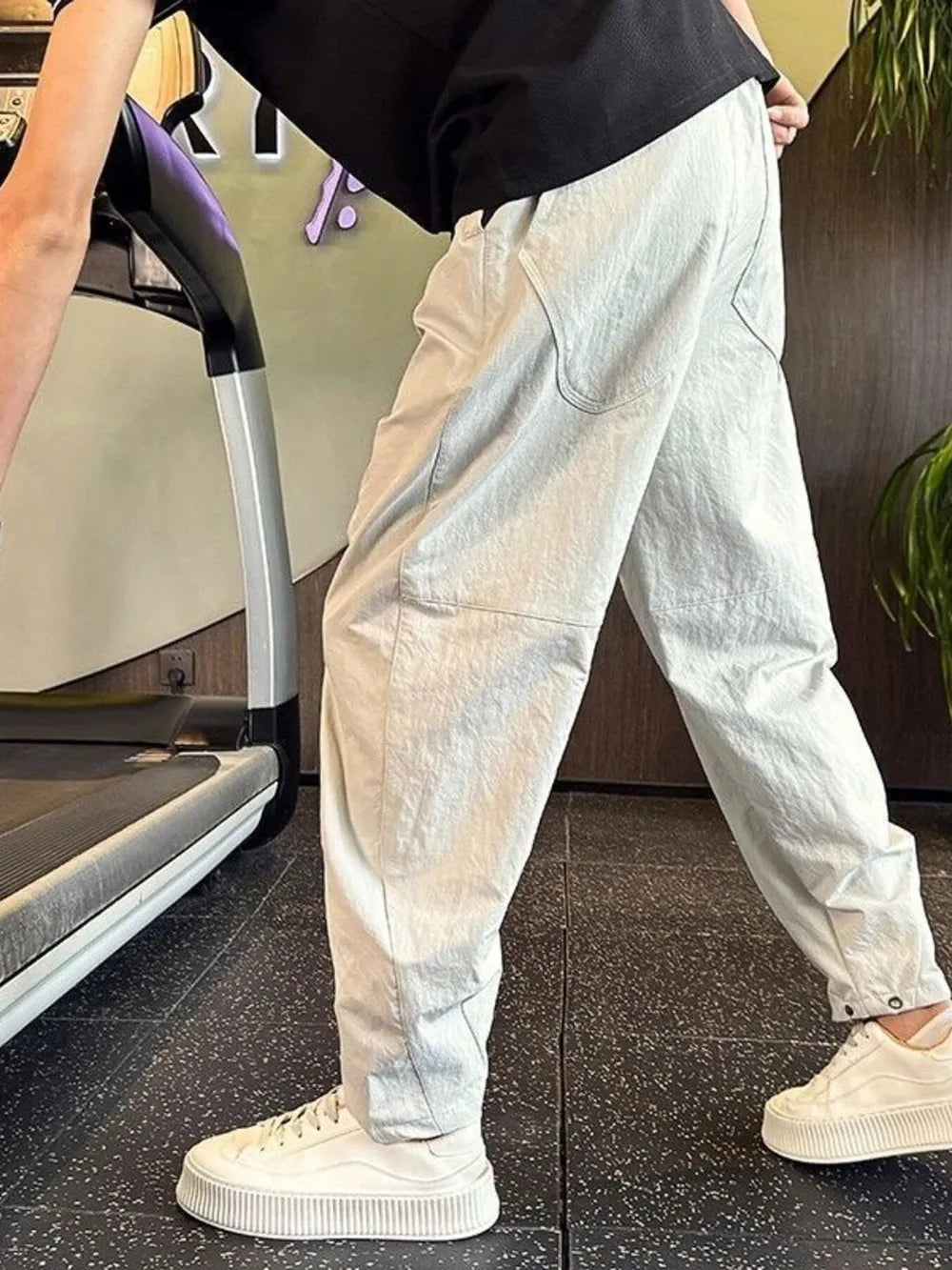 Light gray cargo pants with adjustable cuffs and visible pockets.