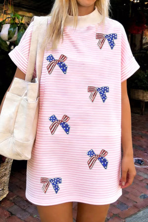 Pink striped mini dress with American flag bow embellishments and a mock neck.