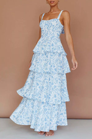 Tiered maxi dress with blue floral print, square neckline, and spaghetti straps.