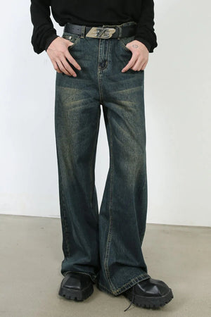 Faded dark denim wide-leg trousers with a relaxed fit and distressed details.