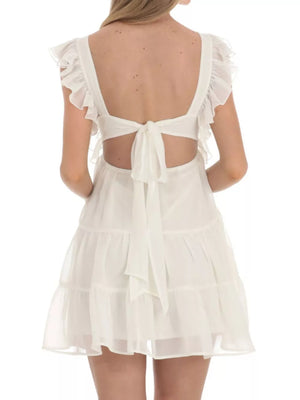 Ivory white mini dress with ruffled sleeves, open back, and tie detail.