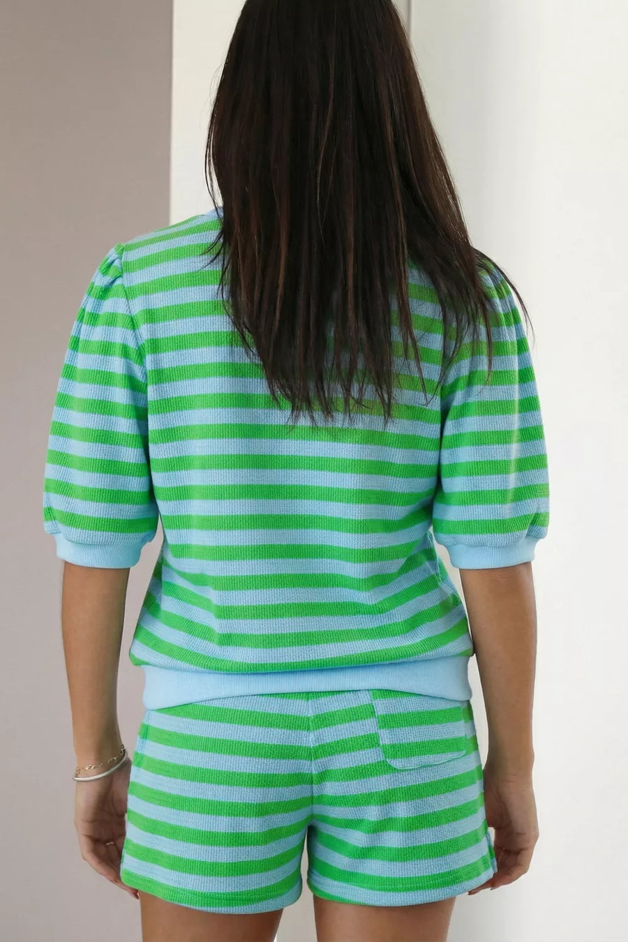 Striped green and blue knit top with puff sleeves and matching shorts.
