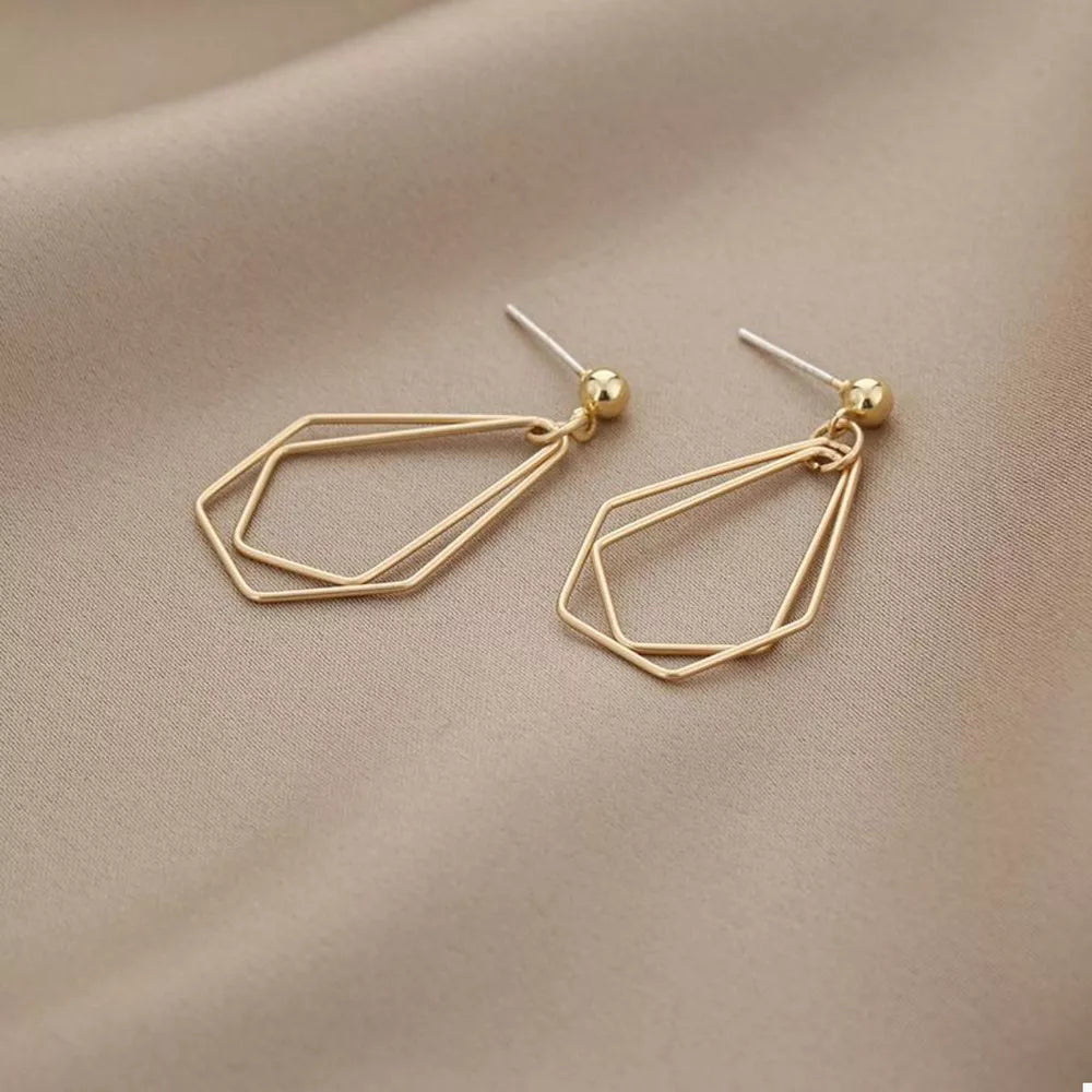 Gold earrings featuring drop earrings and geometric