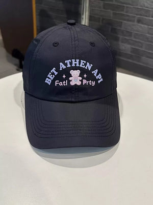 Black baseball cap with embroidered teddy bear and text detail