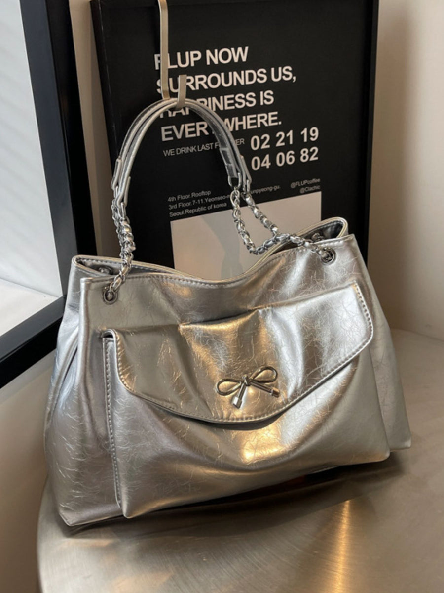 silver with handbag with bow accent