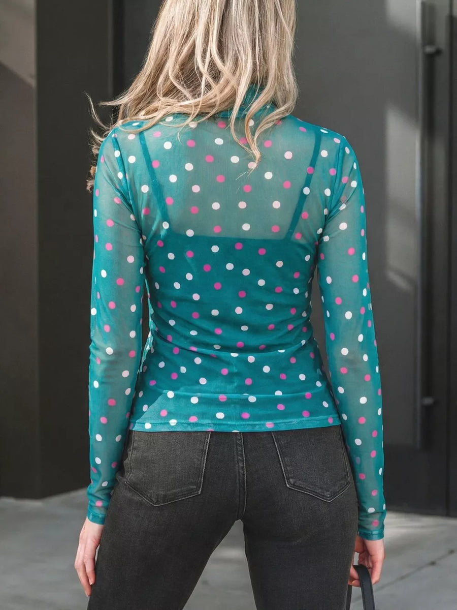 Sheer polka dot mock neck shirt in Air Force Blue with pink and white dots, long sleeves.